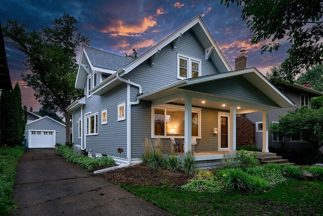 4448 Aldrich Ave S, Minneapolis, MN 55419 - view of front of property with a porch, an outdoor structure, concrete driveway, a detached garage, and a chimney