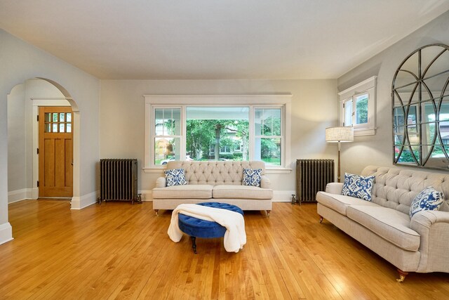 4448 Aldrich Ave S, Minneapolis, MN 55419 - living area with radiator heating unit, arched walkways, and healthy amount of natural light