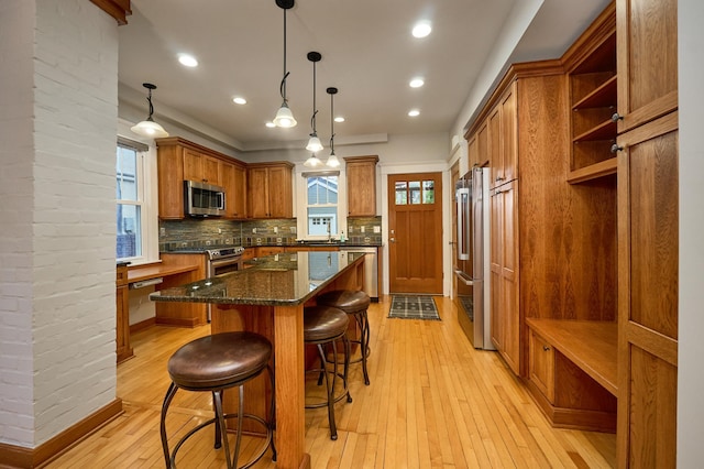 4448 Aldrich Ave S, Minneapolis, MN 55419 - kitchen featuring a kitchen island, appliances with stainless steel finishes, open shelves, brown cabinetry, and recessed lighting