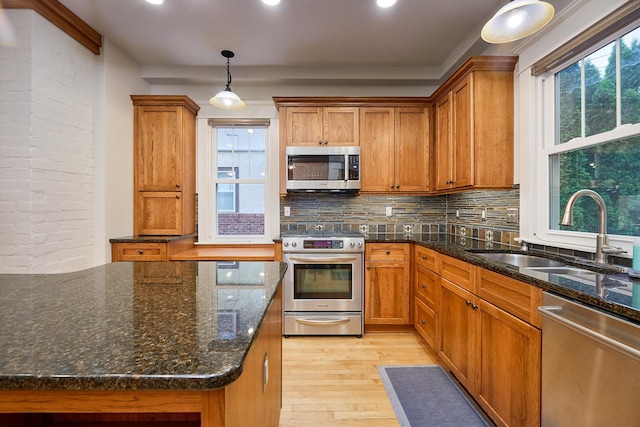 4448 Aldrich Ave S, Minneapolis, MN 55419 - kitchen featuring stainless steel appliances, light wood-style floors, brown cabinets, decorative backsplash, and recessed lighting