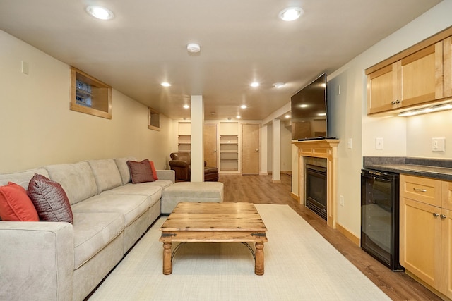 4448 Aldrich Ave S, Minneapolis, MN 55419 - living room with wine cooler, wood finished floors, recessed lighting, bar area, and a tiled fireplace