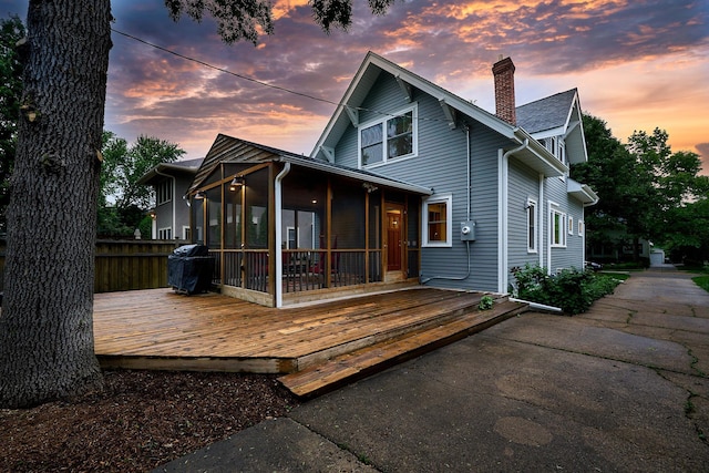4448 Aldrich Ave S, Minneapolis, MN 55419 - rear view of house with a sunroom, a chimney, and a wooden deck