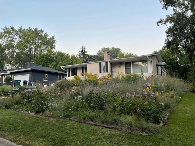 2479 Oxford St N, Roseville, MN 55113 - ranch-style house with a chimney, a front lawn, stucco siding, and a garage