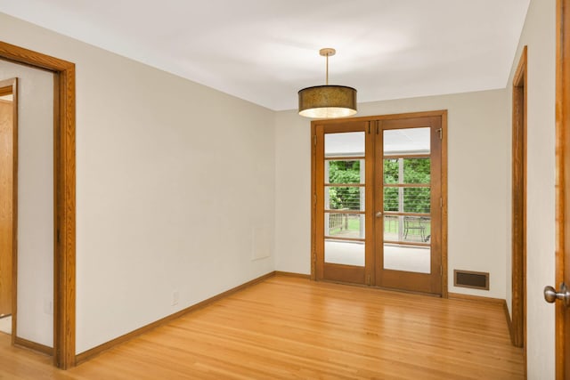 2479 Oxford St N, Roseville, MN 55113 - empty room with french doors, light wood-type flooring, and baseboards