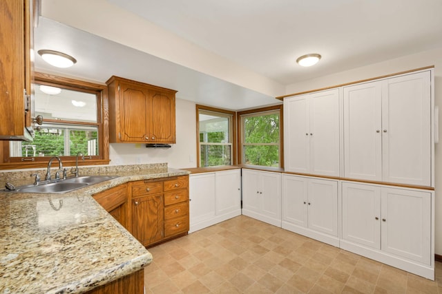 2479 Oxford St N, Roseville, MN 55113 - kitchen featuring a sink, brown cabinets, and light flooring