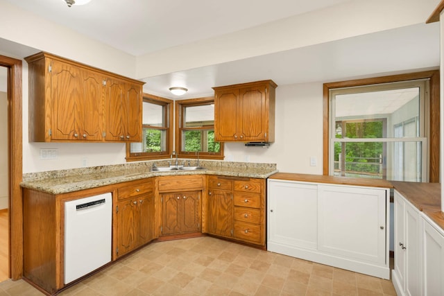2479 Oxford St N, Roseville, MN 55113 - kitchen featuring white dishwasher, a sink, plenty of natural light, and brown cabinetry