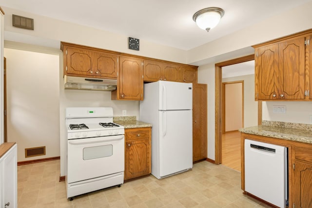 2479 Oxford St N, Roseville, MN 55113 - kitchen featuring white appliances, under cabinet range hood, and brown cabinets