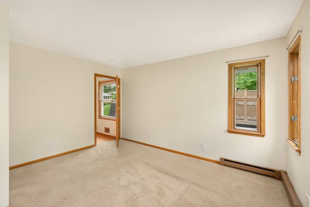 2479 Oxford St N, Roseville, MN 55113 - carpeted spare room with a baseboard heating unit and baseboards