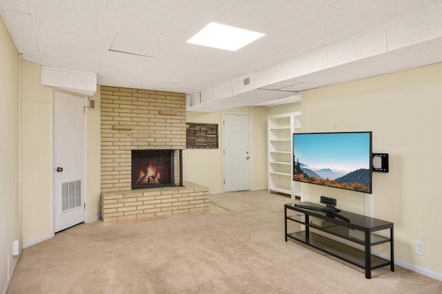 2479 Oxford St N, Roseville, MN 55113 - carpeted living room featuring a fireplace, baseboards, and a drop ceiling