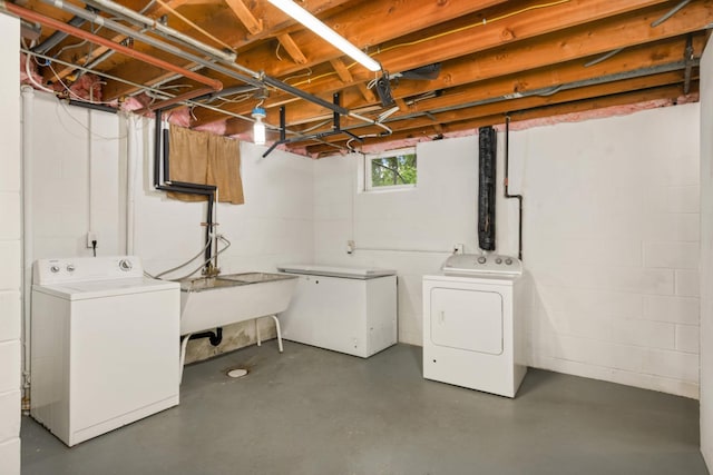 2479 Oxford St N, Roseville, MN 55113 - basement featuring washer and clothes dryer, refrigerator, concrete block wall, and a sink