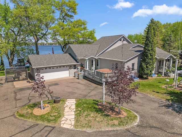 1823 313th Ave NE, Isanti Twp, MN 55008 - view of front of house featuring driveway, an attached garage, roof with shingles, and a wooden deck