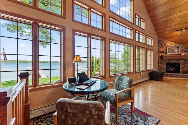 1823 313th Ave NE, Isanti Twp, MN 55008 - sunroom / solarium featuring baseboard heating, lofted ceiling, and a water view