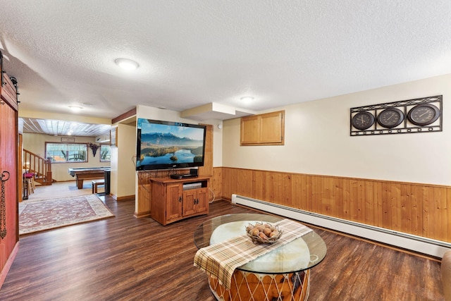 1823 313th Ave NE, Isanti Twp, MN 55008 - living room with a baseboard heating unit, a textured ceiling, wainscoting, dark wood-type flooring, and billiards