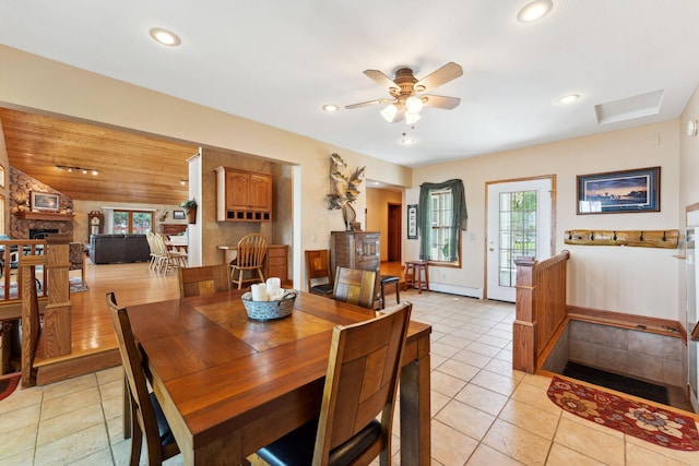 1823 313th Ave NE, Isanti Twp, MN 55008 - dining room with a ceiling fan, light tile patterned flooring, recessed lighting, a baseboard radiator, and a stone fireplace