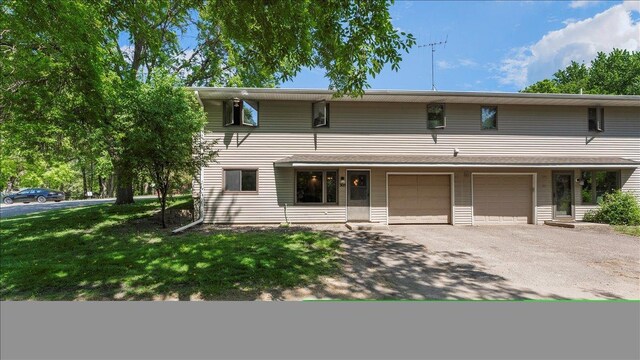 305 Arcadian Pl Unit 1, Buffalo, MN 55313 - multi unit property featuring driveway, an attached garage, and a front yard