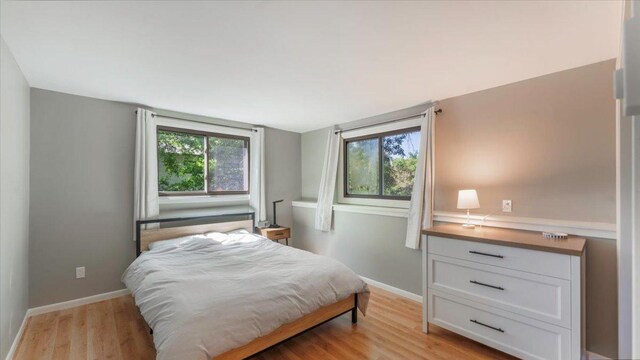 305 Arcadian Pl Unit 1, Buffalo, MN 55313 - bedroom with light wood-style floors and baseboards