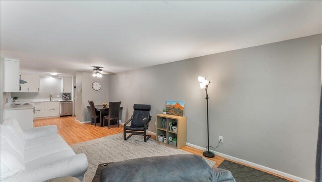 305 Arcadian Pl Unit 1, Buffalo, MN 55313 - living room with light wood-style flooring, ceiling fan, and baseboards