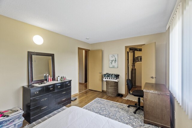 bedroom featuring wood finished floors and baseboards