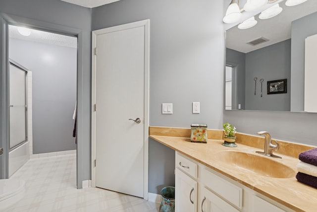 2250 Ridge Dr Unit 11, Saint Louis Park, MN 55416 - bathroom featuring vanity, bath / shower combo with glass door, and baseboards