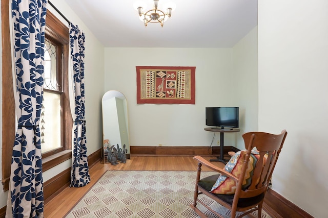 living area with wood finished floors, healthy amount of natural light, and baseboards