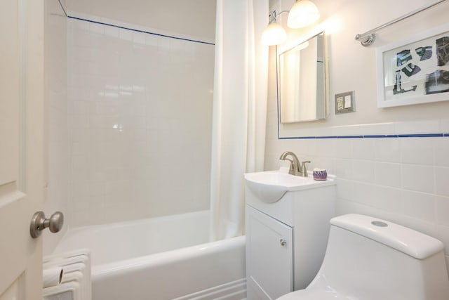 full bath featuring toilet, shower / tub combo with curtain, vanity, tile walls, and radiator heating unit