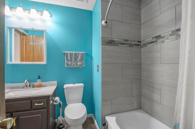 full bathroom with toilet, vanity, and shower / tub combo with curtain