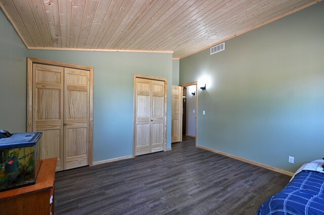 28257 French Rd, Danbury, WI 54830 - unfurnished bedroom with multiple closets, crown molding, baseboards, dark wood-type flooring, and wooden ceiling
