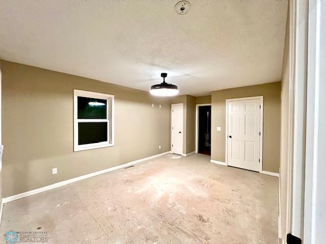 24129 County Road 144, Detroit Twp, MN 56501 - unfurnished room with baseboards and a textured ceiling