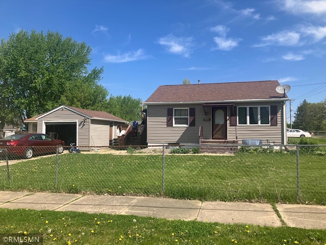 view of front of property featuring an outbuilding, a garage, and a shingled roof