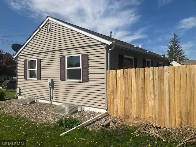 view of home's exterior featuring fence