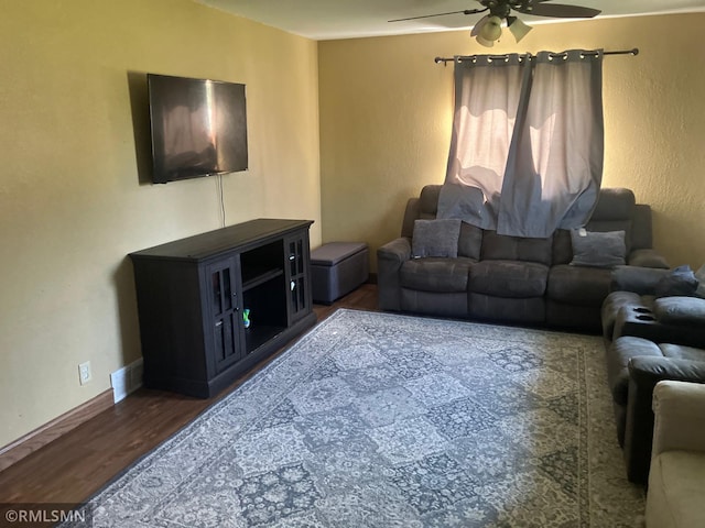 living room featuring ceiling fan and wood finished floors