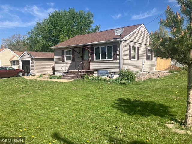 view of front of home with central air condition unit, a front yard, and a shingled roof