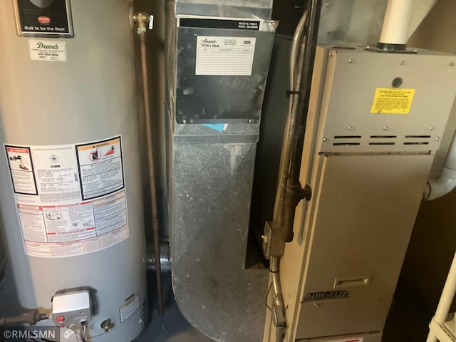 utility room featuring water heater