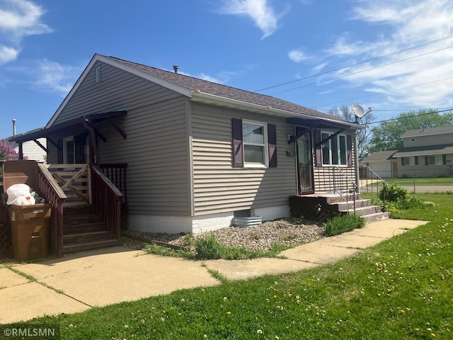 view of side of property featuring roof with shingles