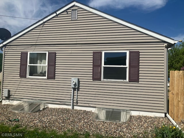 view of side of home with fence