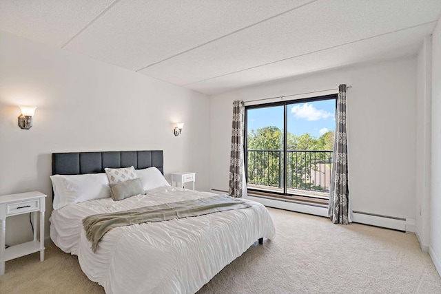 bedroom featuring baseboard heating, light carpet, and access to outside
