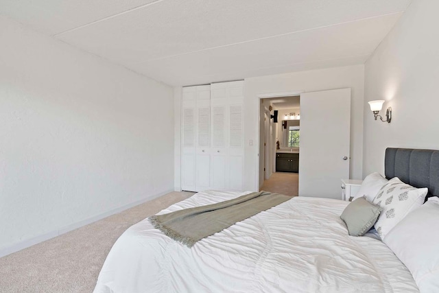 bedroom featuring carpet, a closet, and baseboards