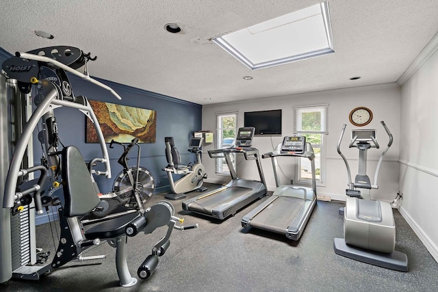 workout area with crown molding, a textured ceiling, and baseboards