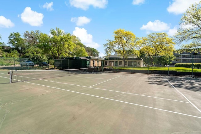 view of tennis court featuring fence