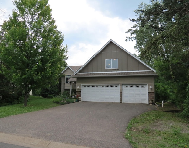 23141 Hilo Ave N, Forest Lake, MN 55025 - view of front facade featuring board and batten siding, driveway, and an attached garage