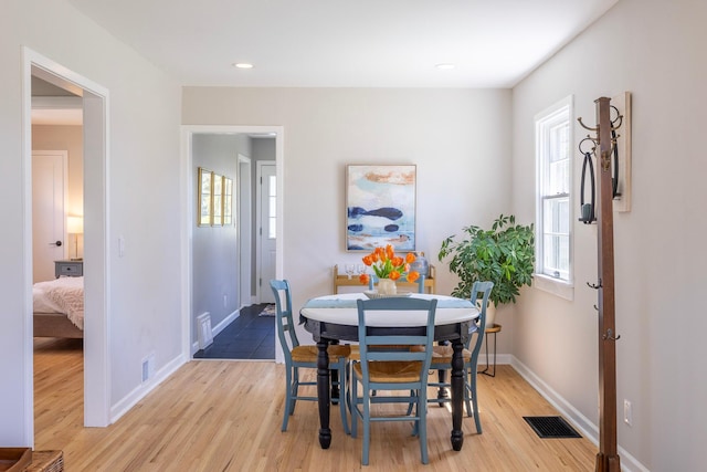 dining area featuring light wood finished floors, baseboards, and recessed lighting