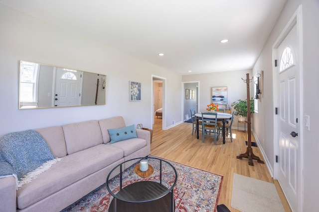living room featuring light wood-style floors, recessed lighting, and baseboards