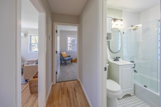 full bathroom with plenty of natural light, tub / shower combination, vanity, and toilet