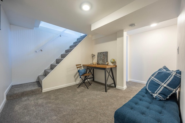 finished basement featuring carpet flooring, stairs, and baseboards
