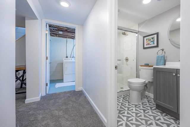 full bathroom featuring washer / clothes dryer, a shower stall, toilet, vanity, and baseboards