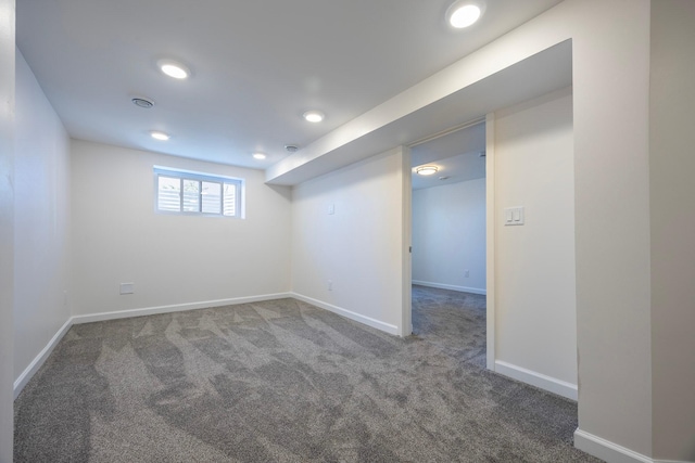 basement featuring carpet flooring, baseboards, and recessed lighting