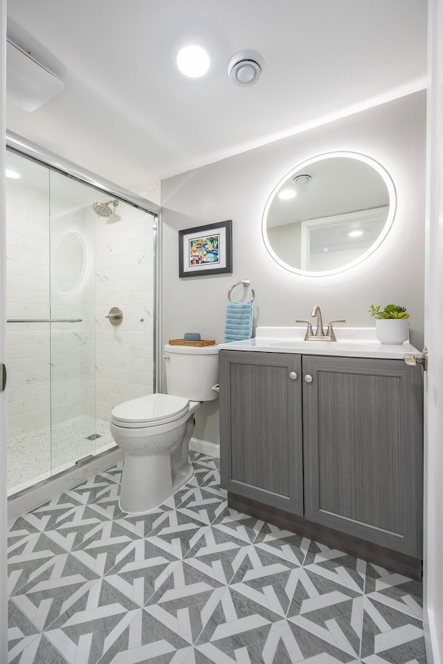 full bath with toilet, a stall shower, tile patterned floors, and vanity