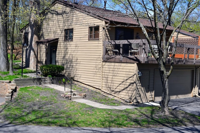 109 Eagle Lake Dr, Maple Grove, MN 55369 - view of side of property featuring an attached garage, asphalt driveway, and a balcony