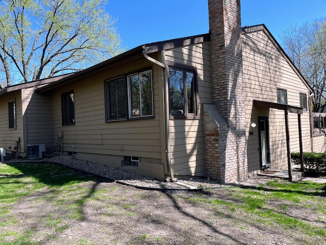 109 Eagle Lake Dr, Maple Grove, MN 55369 - view of side of home featuring a chimney and central air condition unit