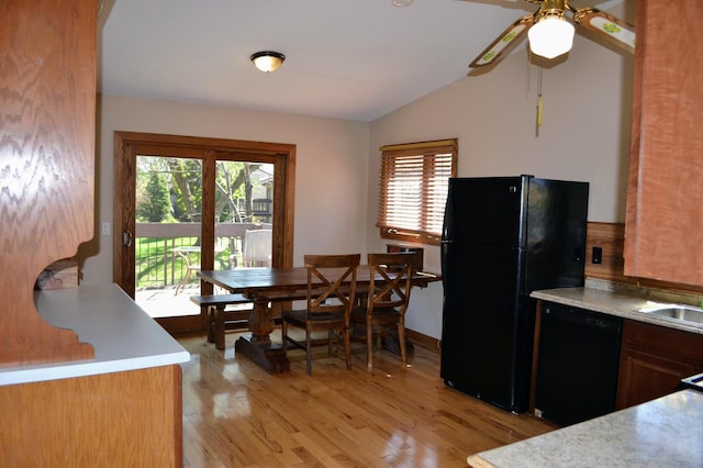 109 Eagle Lake Dr, Maple Grove, MN 55369 - kitchen with black appliances, light countertops, vaulted ceiling, ceiling fan, and light wood-style flooring